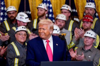 President Donald Trump reacts alongside the employees of the coal industry, on the day on which he signed energy -related executive commands in the White House